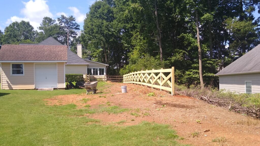 white wooden picket fence with landscaped yard Alpharetta