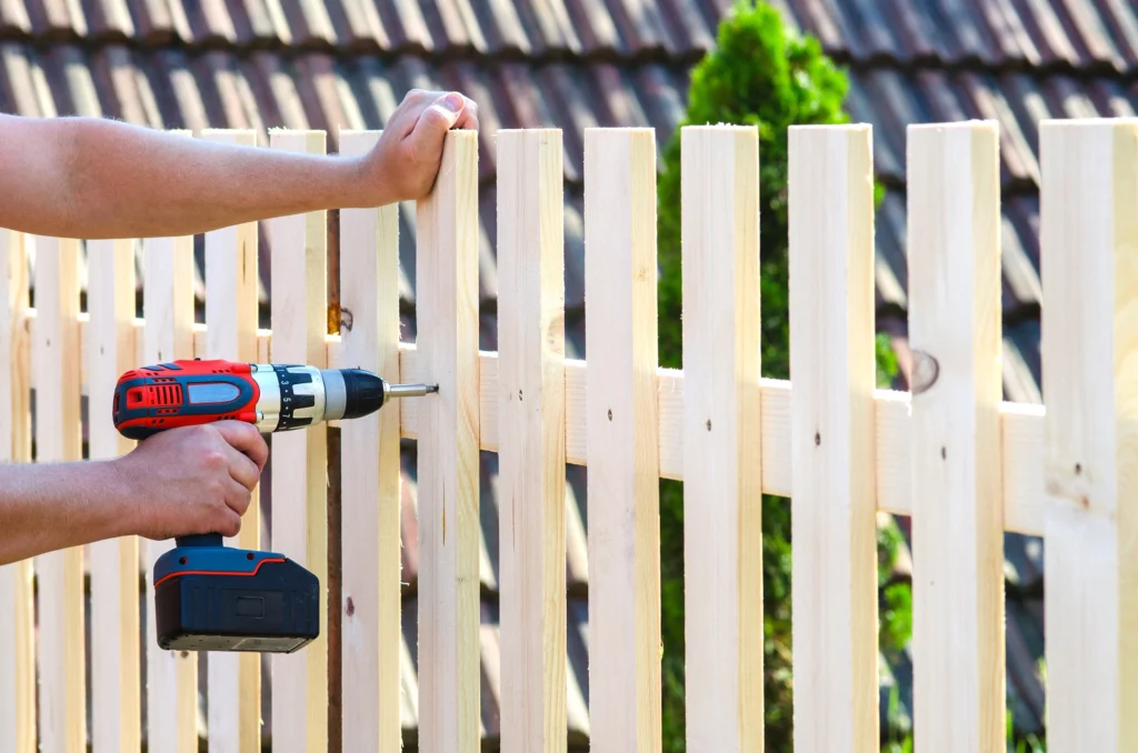 Fence Repair in Atlanta Metro Area - GA underway as a crew resets a leaning backyard post