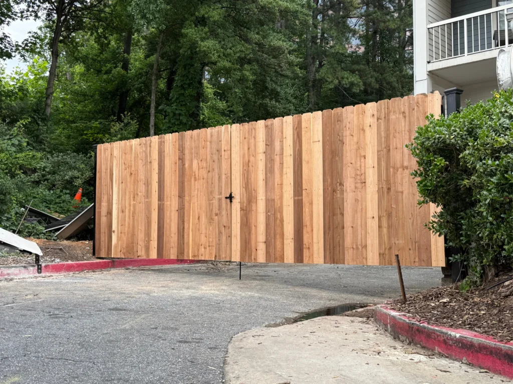 Technician testing automatic Driveway Gates at a McDonough - GA property entrance before final adjustment